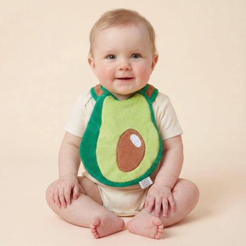 baby wearing avocado-shaped drool bib, neutral aesthetic handmade bib
