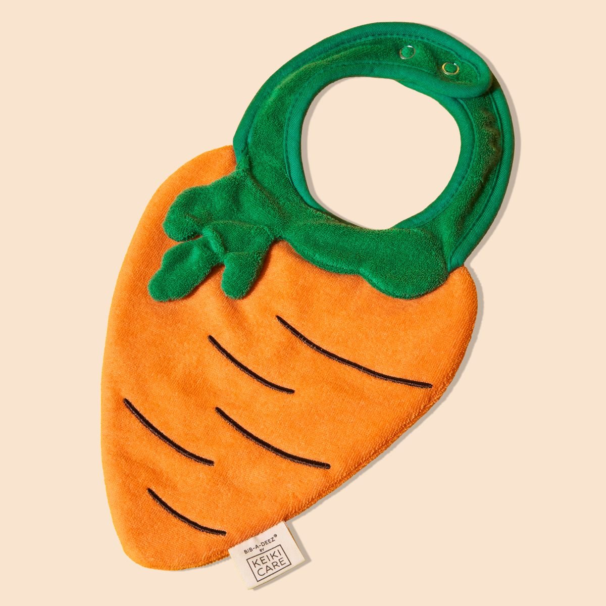 carrot drool bib flat lay, bright and playful handmade baby accessory