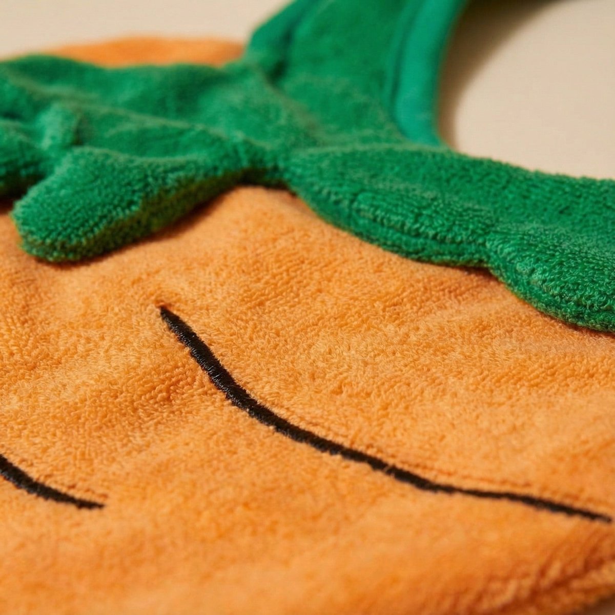 carrot baby bib close-up stitching and soft cotton detail